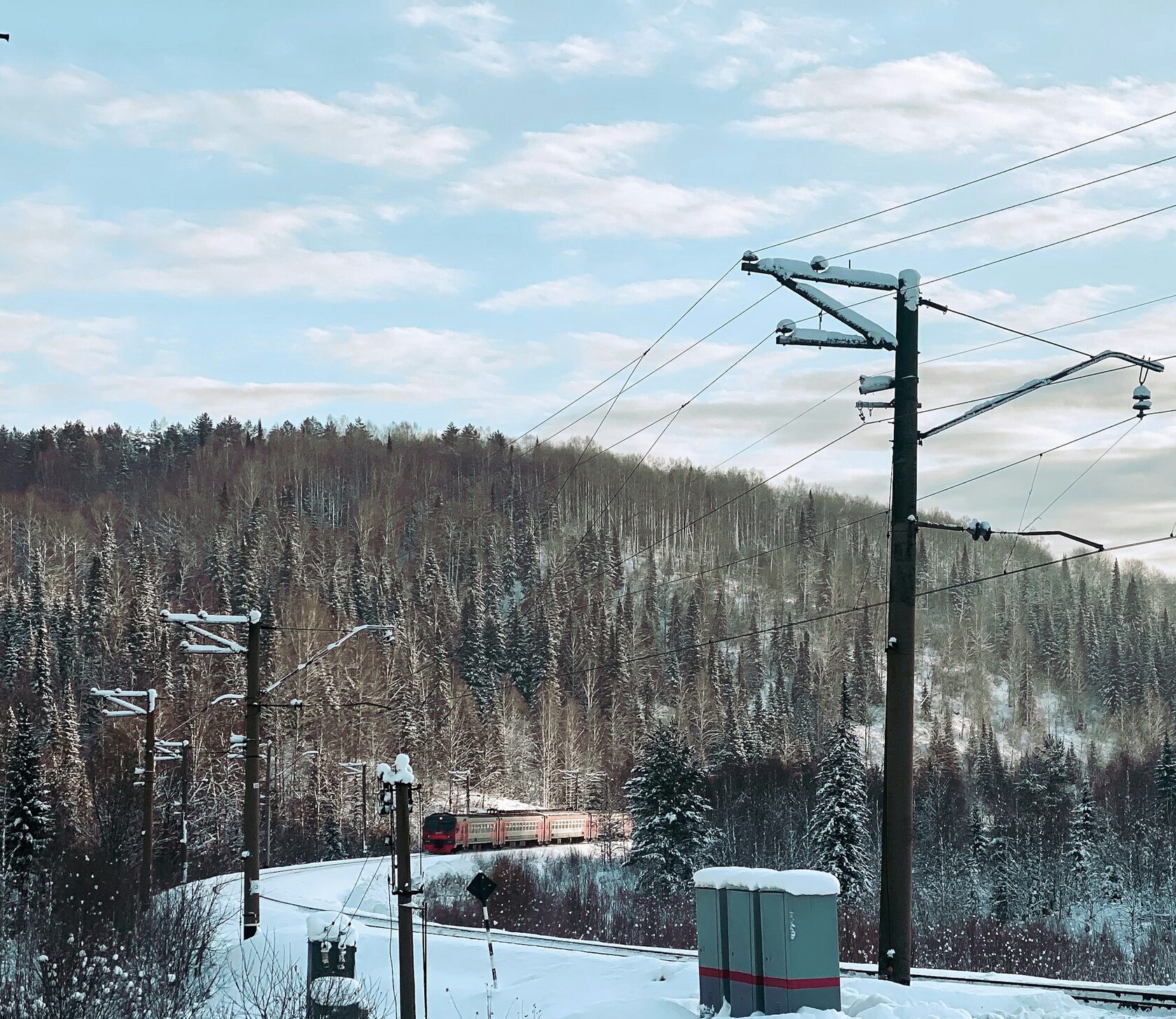 a train traveling through a snow covered forest