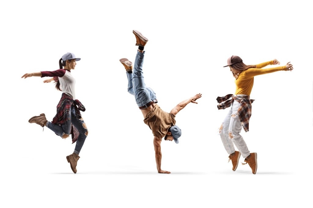 El dance. American male Dancer performing a Handstand with a Boombox isolated on White background.