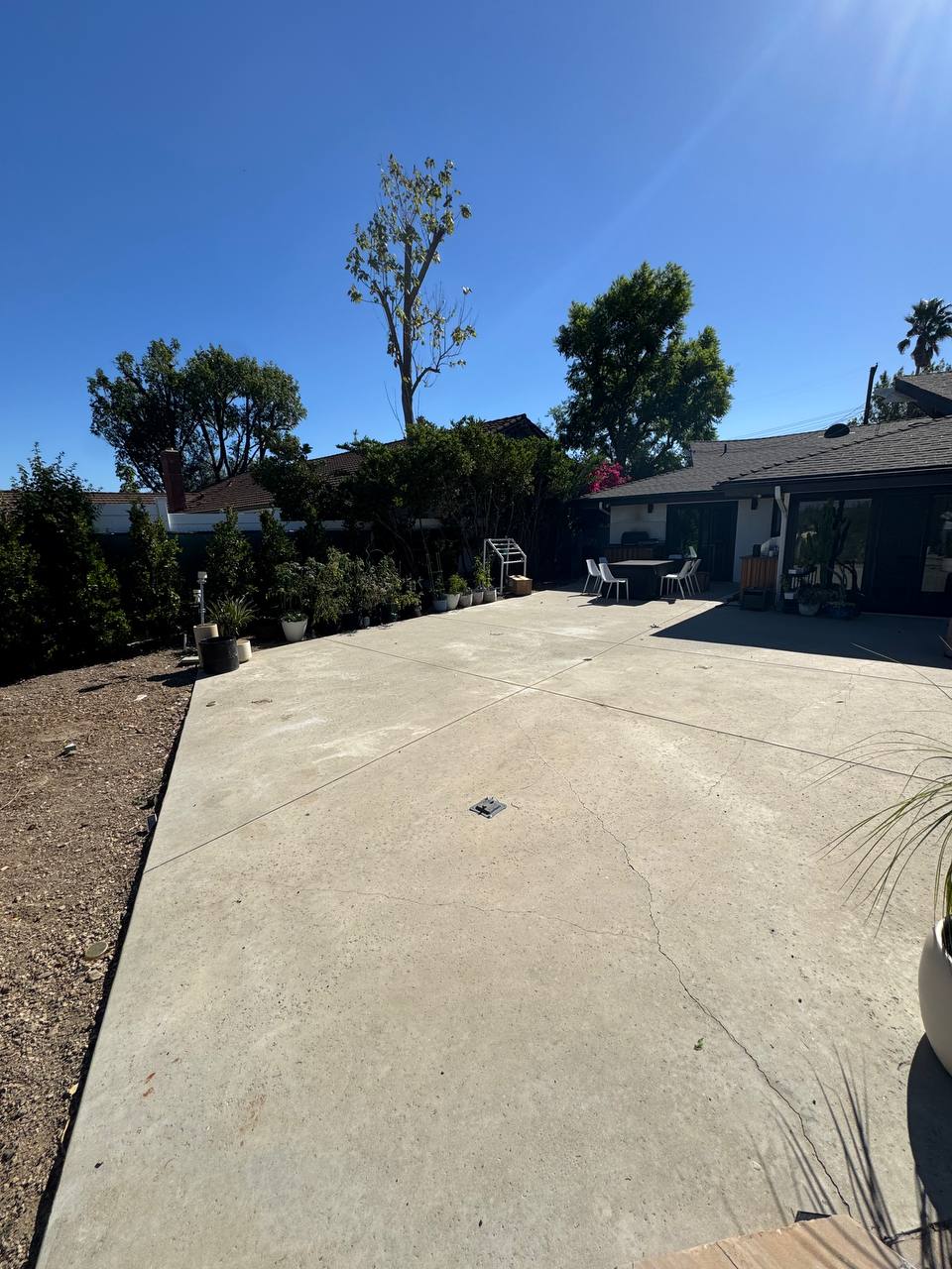 Poolside concrete patio before pergola installation in Newport