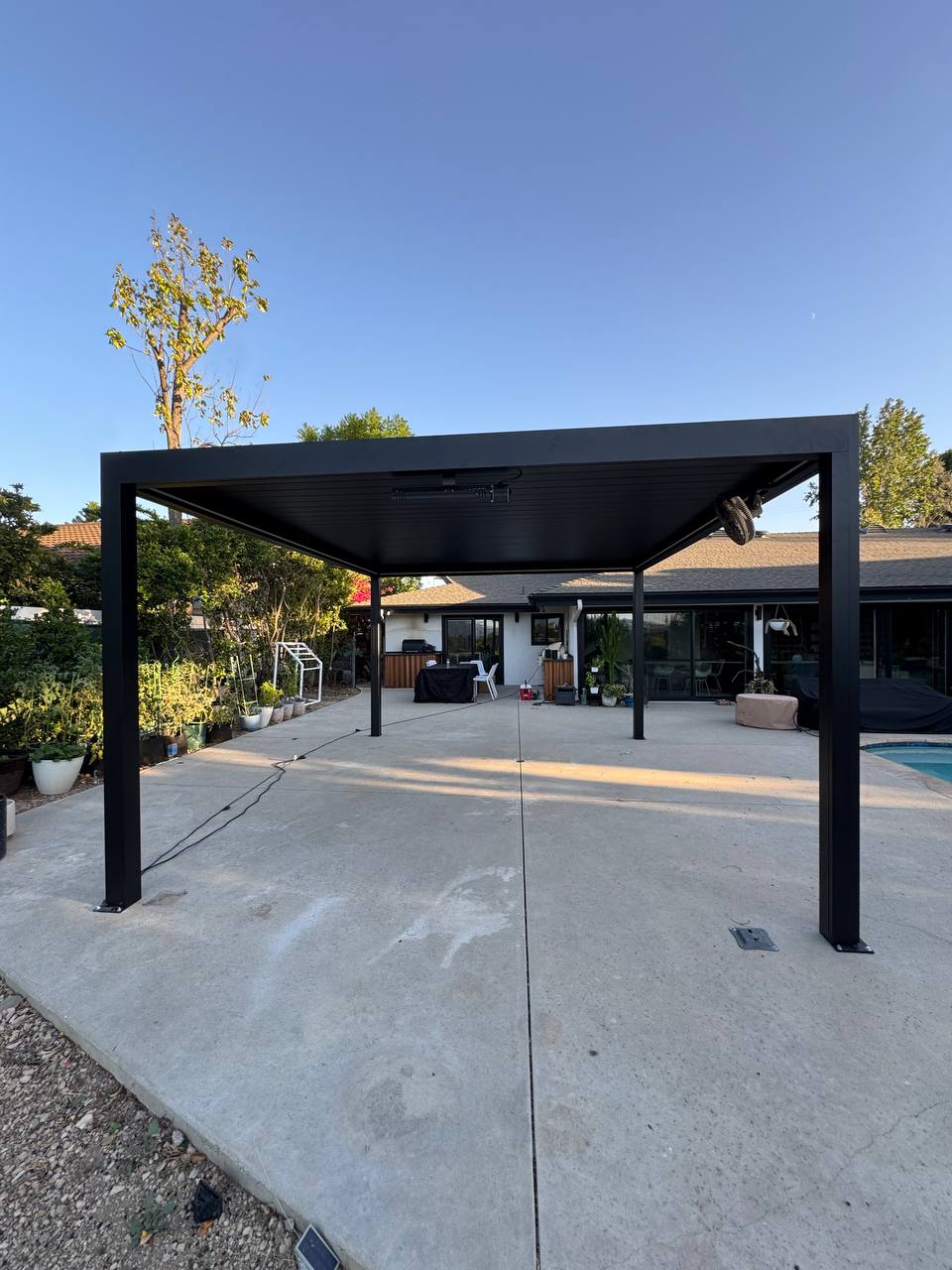 Completed dark gray freestanding 13x15 motorized pergola in Newport, project view 1