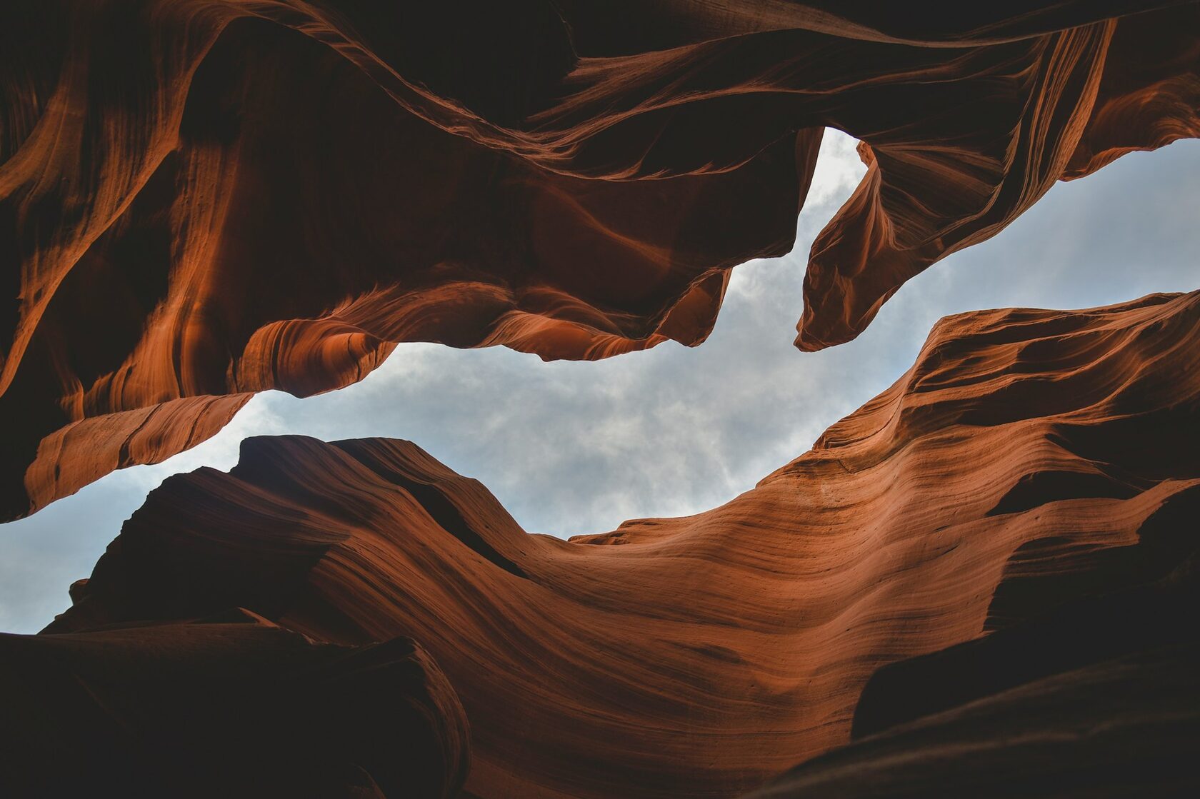 Deep red rock canyon with dramatic cliffs and narrow passage