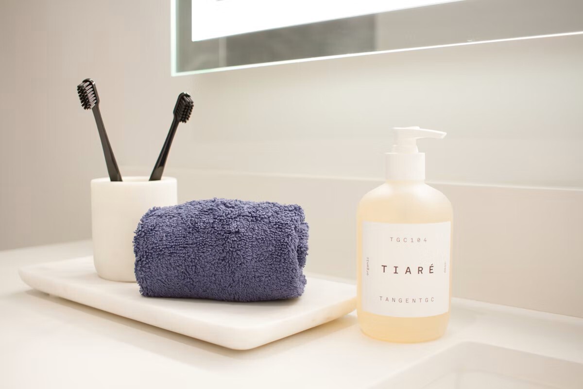 Bathroom counter accessories arranged on a light surface