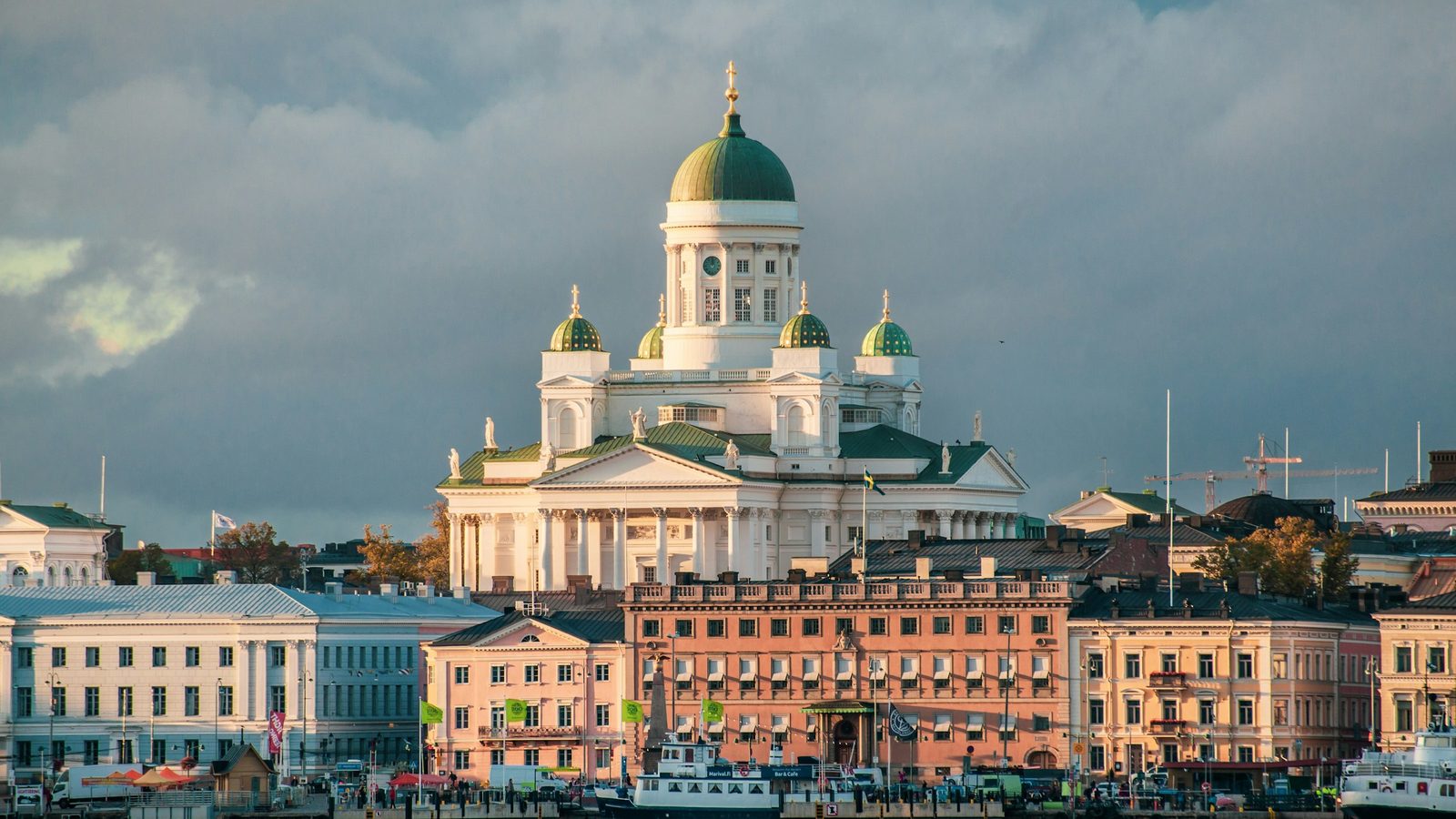Helsinki Cathedral with its green domes above the pastel buildings of the South Harbour waterfront