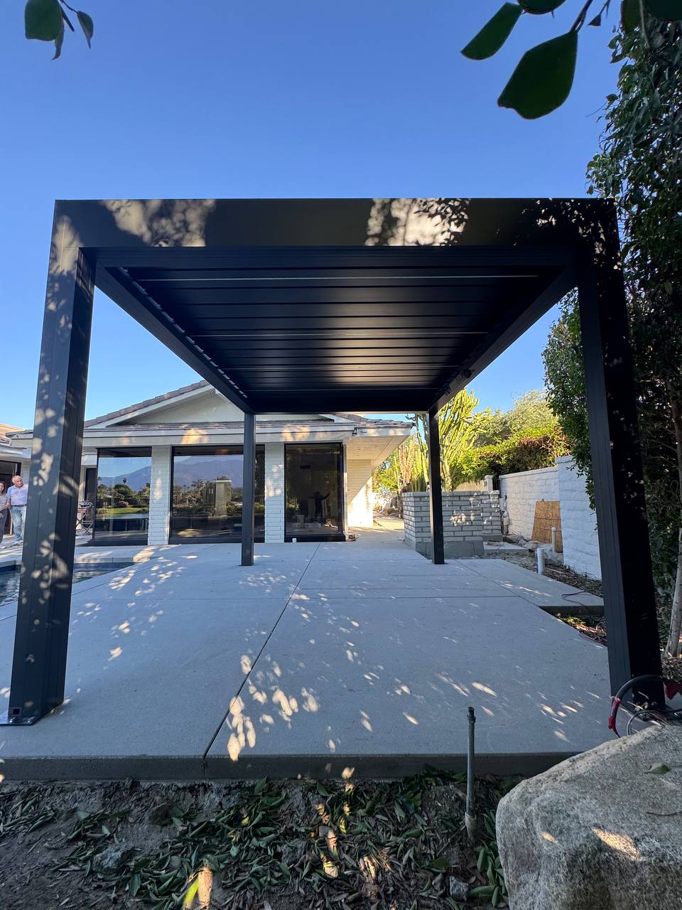 Completed motorized pergola viewed toward the house