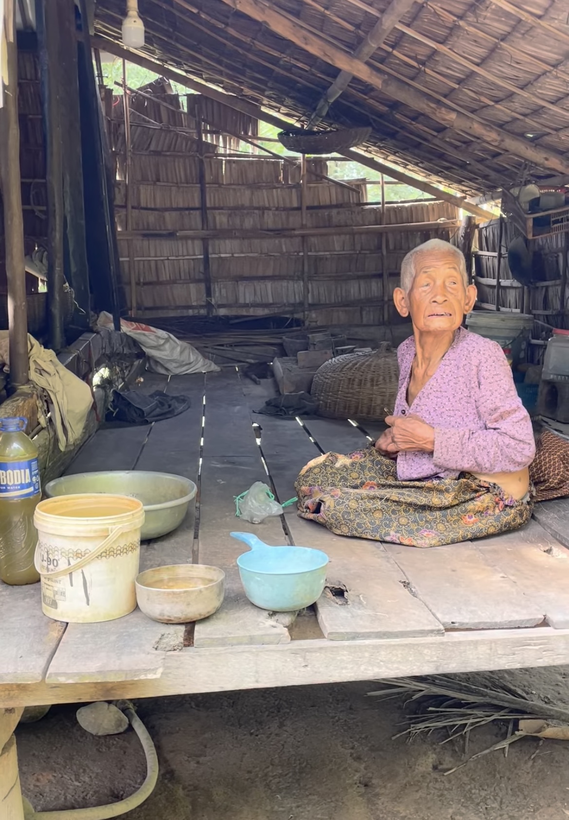 An elderly Cambodian woman resting in a rural village