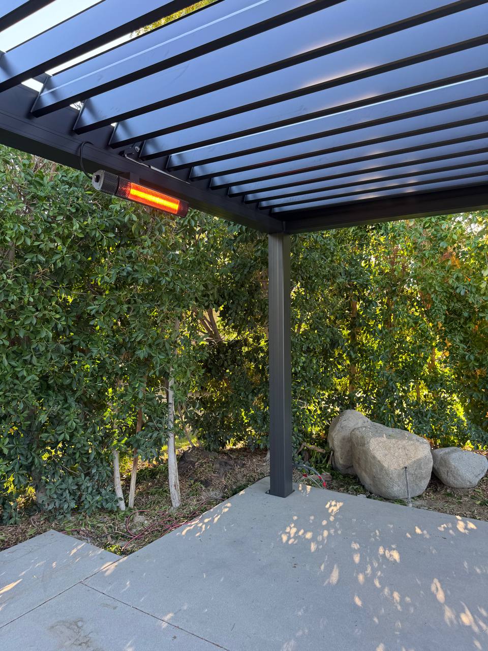 Operating infrared heater beneath the Lake Forest pergola roof