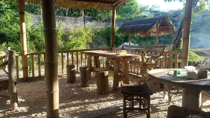 A rustic and traditional wooden and bamboo dining area with a relaxed local feel, known for serving large, authentic portions of home-cooked Russian food in Bali.