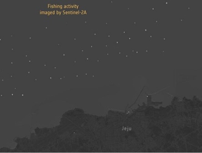 Nighttime imagery from Sentinel-2A of the sea off the coast of the South Korea, showing a scattering of small white dots, which are the lights of fishing boats.