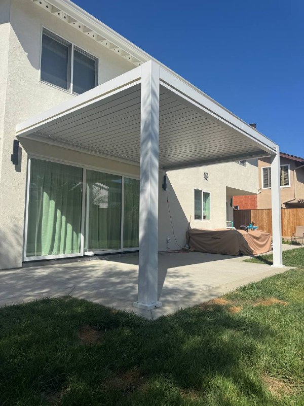 Completed white aluminum motorized pergola in Huntington Beach backyard