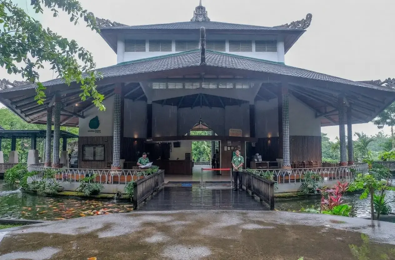 The welcoming open-air main entrance and ticketing lobby featuring a beautiful koi pond, where visitors begin their journey into Monkey Forest Ubud.
