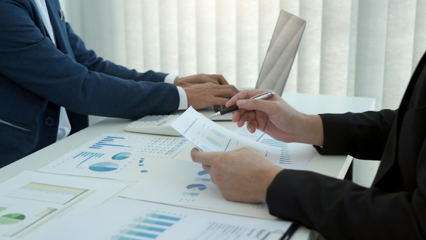 Two professionals engaged in debt and capital advisory services.