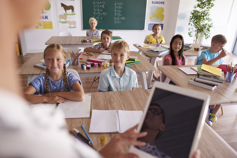 Teacher teaching from digital tablet