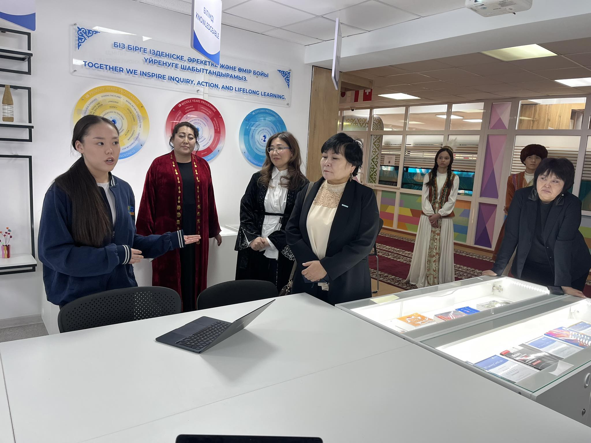 May be an image of one or more people, newsroom and text