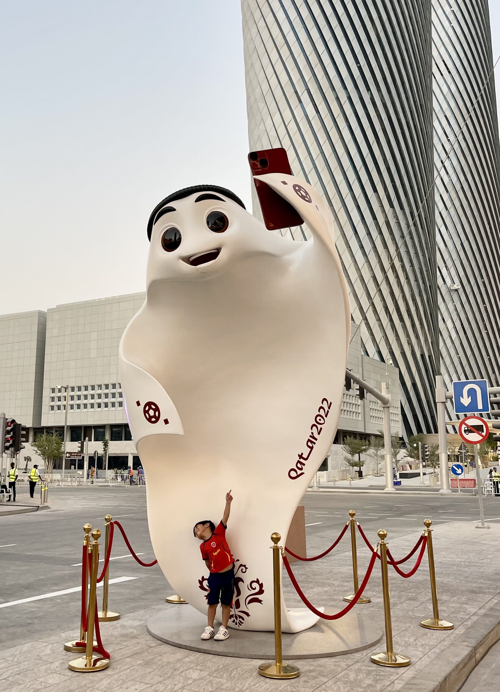 Large outdoor mascot sculpture installation attracting visitors in sporting event fan zone