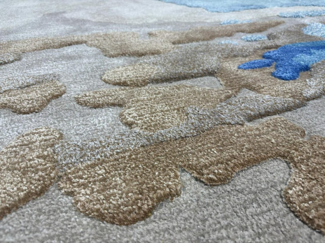 Close-up of a bespoke rug pattern, blue and tan