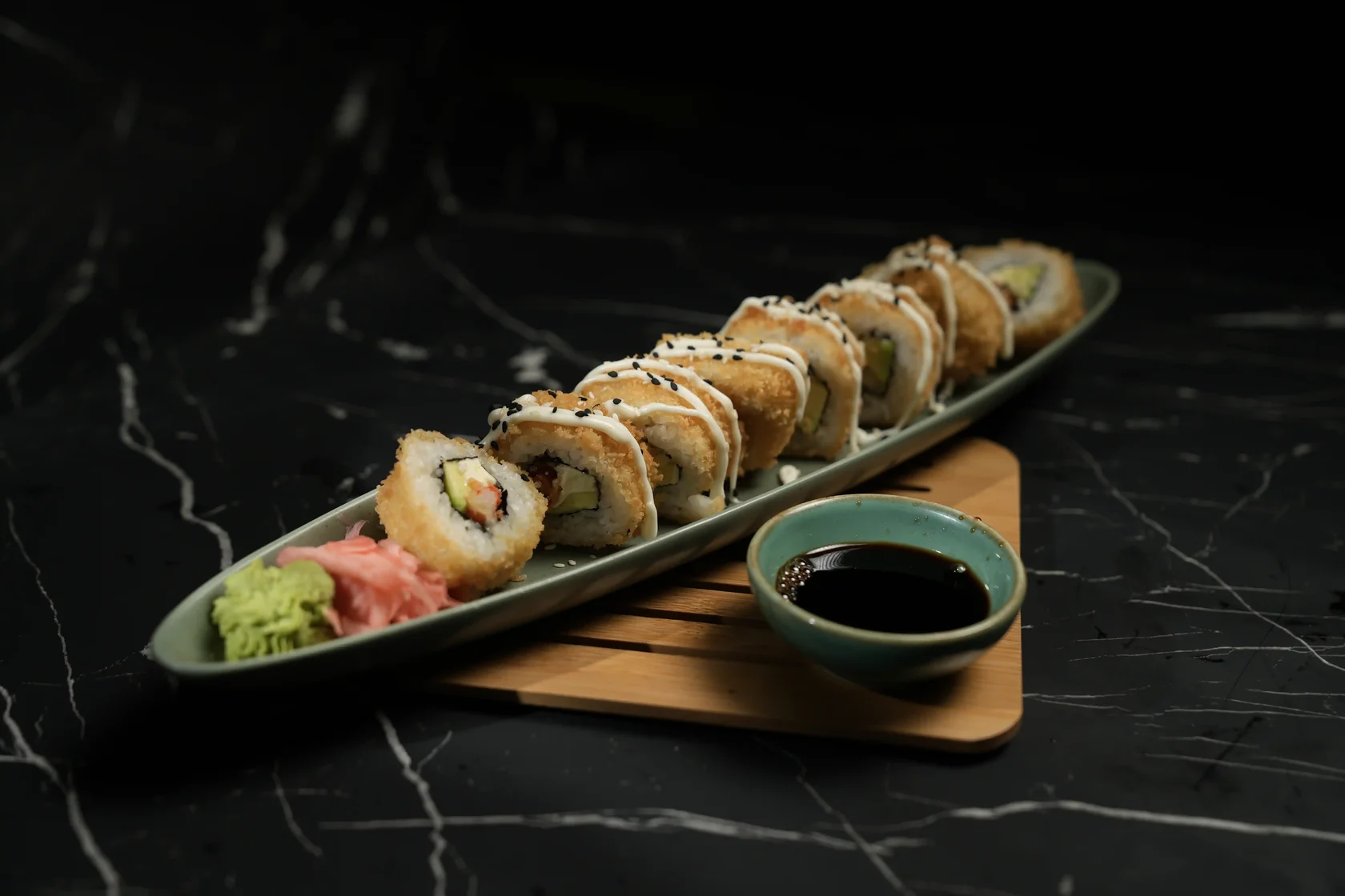 Eight-piece crispy prawn tempura roll with avocado, cream cheese, and Japanese mayo