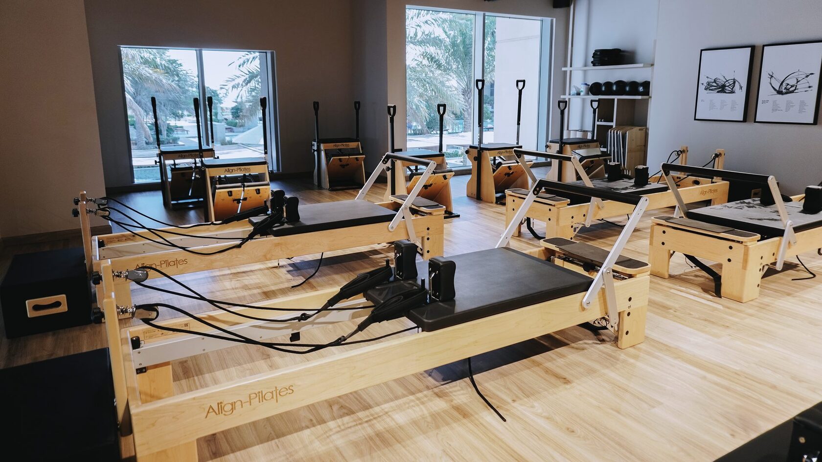 Reformer studio at ART OF PILATES Dubai, daylight through floor-to-ceiling windows