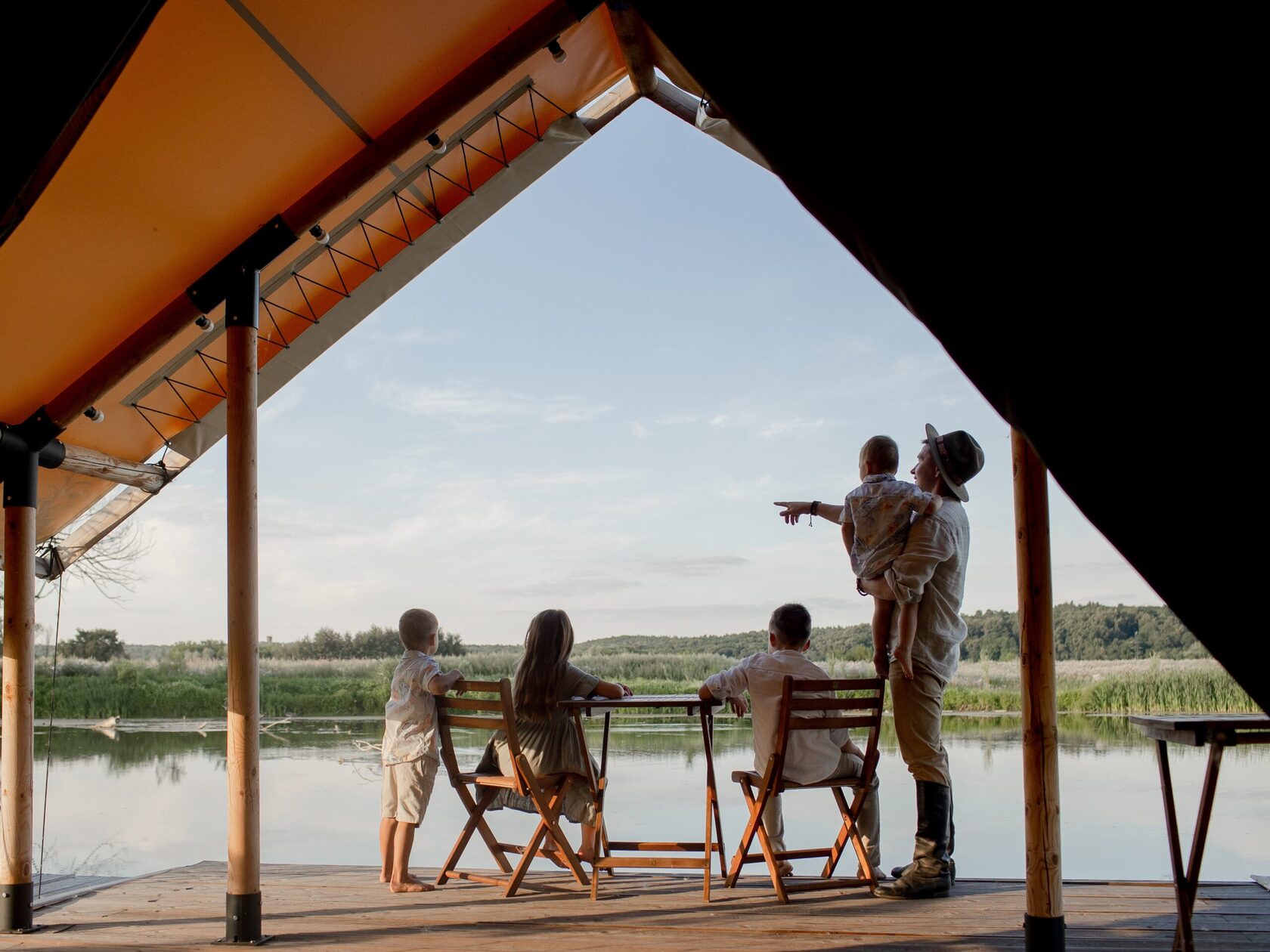 Breakfast inside a safari tent at Ostrov Glamping, with the lake a few steps away