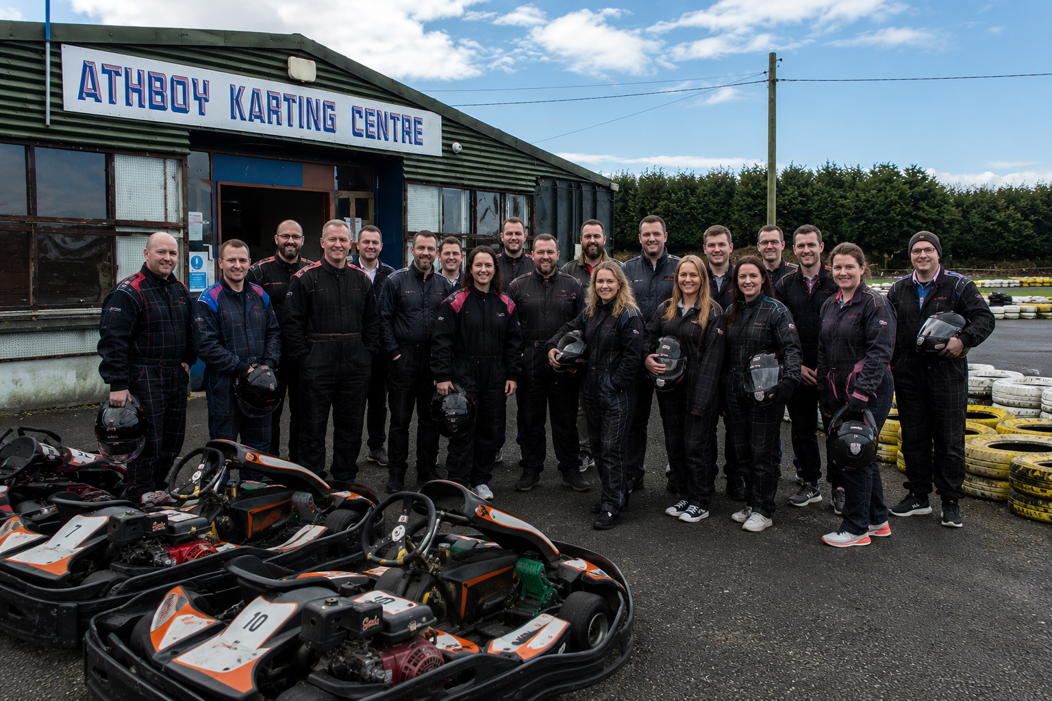 Corporate group holding helmets before outdoor go karting at Athboy Karting Centre in Co. Meath