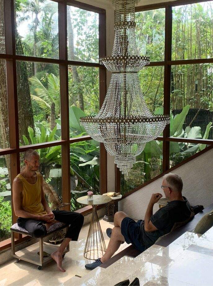 Timur holding a private session with a client in a hall with panoramic windows