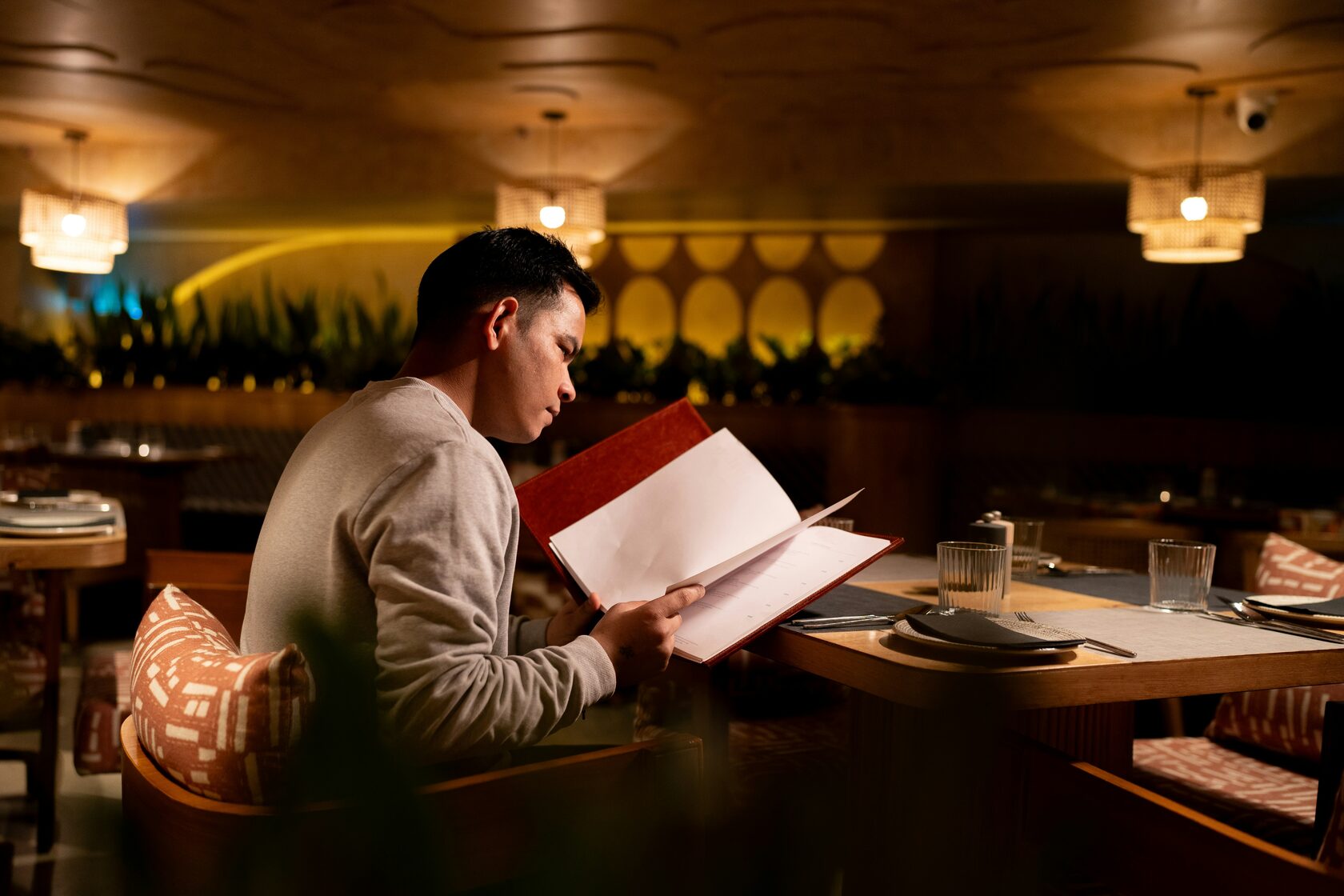 International tourists reading menu at Italian restaurant