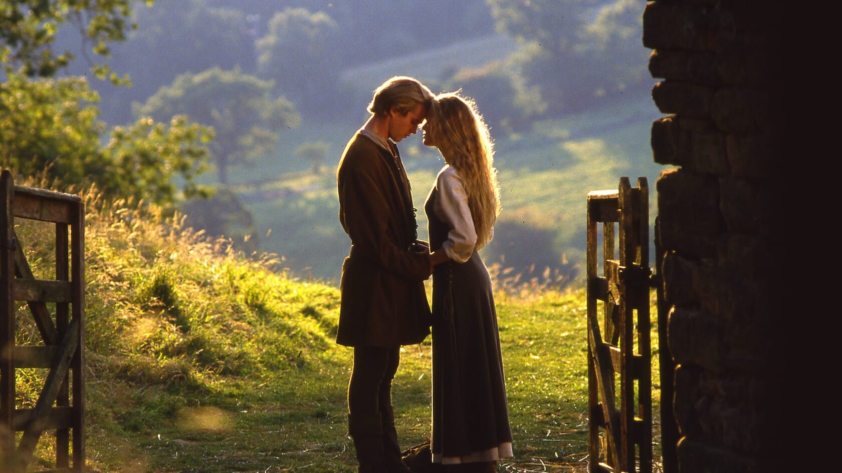 The Princess Bride: Westley and Buttercup stand in an open fence gate, foreheads touching.