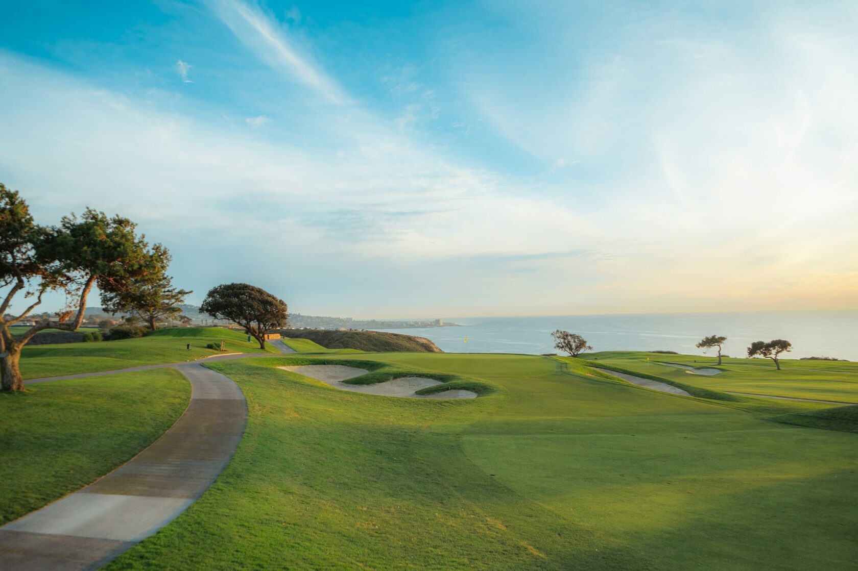 Championship golf course framed by tropical palms and rolling fairways