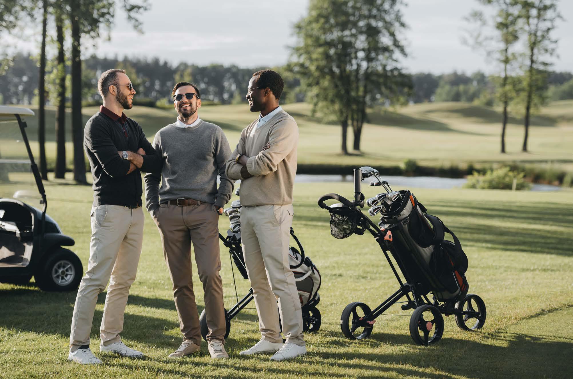 3 golf players smiling in excitement in the golf course