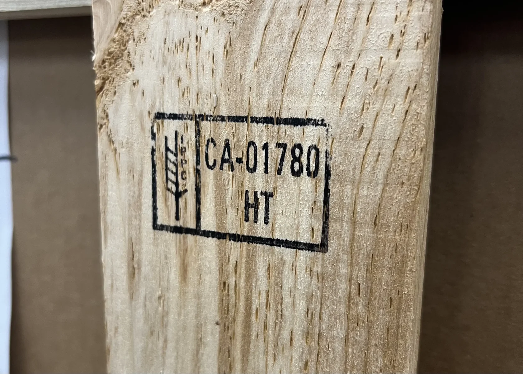 ISPM 15 certification stamp on heat-treated wooden export crate