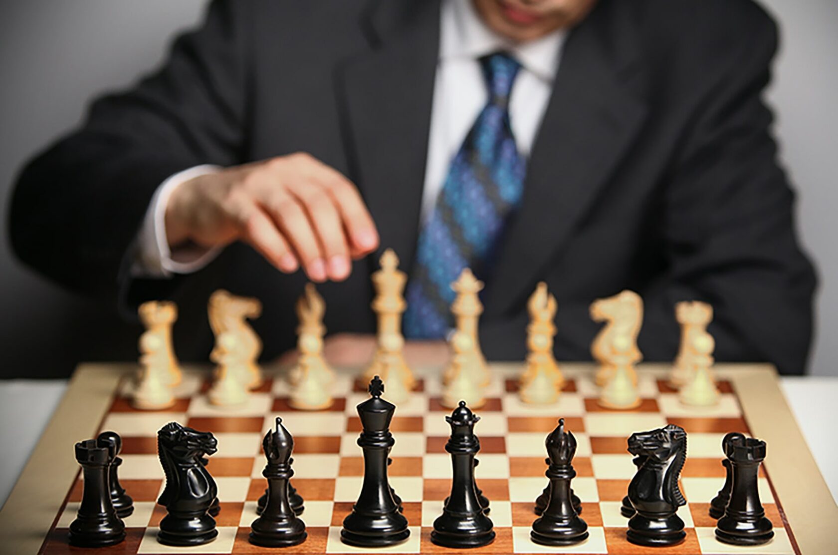 A man playing chess along on the board