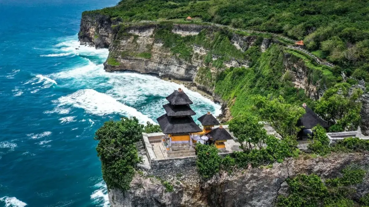 Pura Uluwatu temple perched on a limestone cliff, a dramatic Bali sacred location overlooking the Indian Ocean.