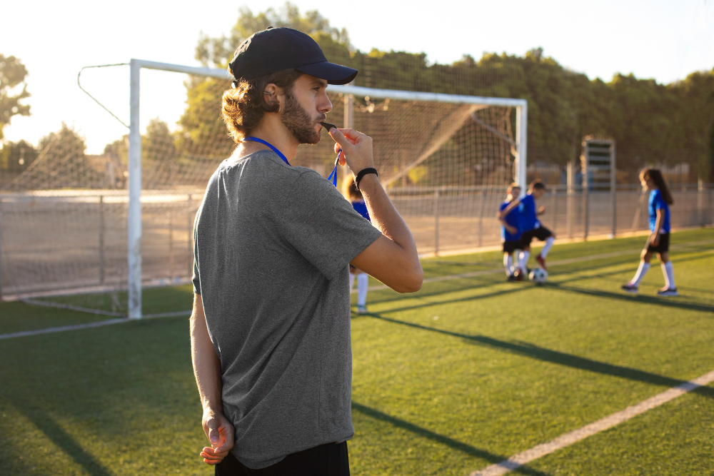 Football Trainer hand in a Pocket