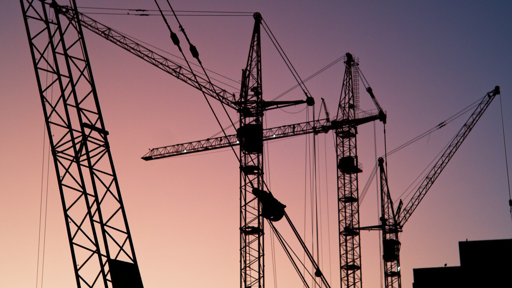 Tower cranes at sunset
