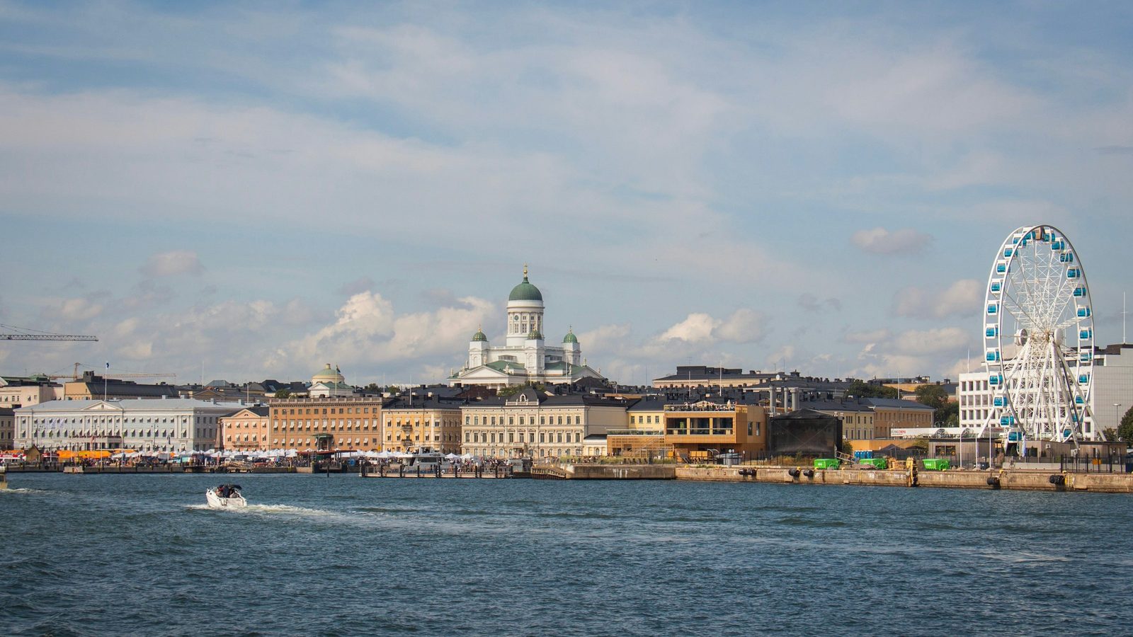 Helsinki seen from the sea: the South Harbour waterfront with Helsinki Cathedral's green dome in the middle and the SkyWheel Ferris wheel on the right
