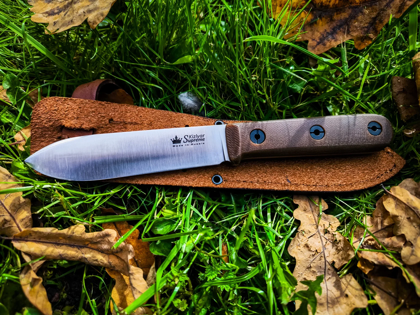 Full side profile of the Kephart outdoor knife on its leather sheath