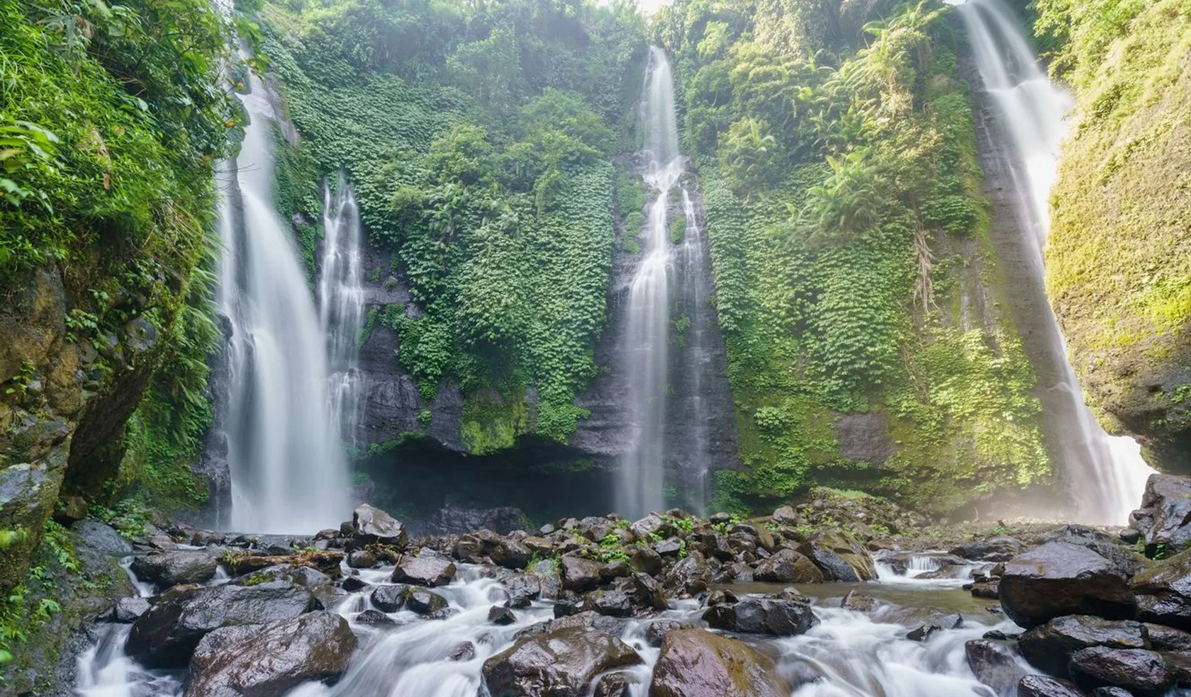 Sekumpul Waterfall surrounded by lush tropical forest in North Bali
