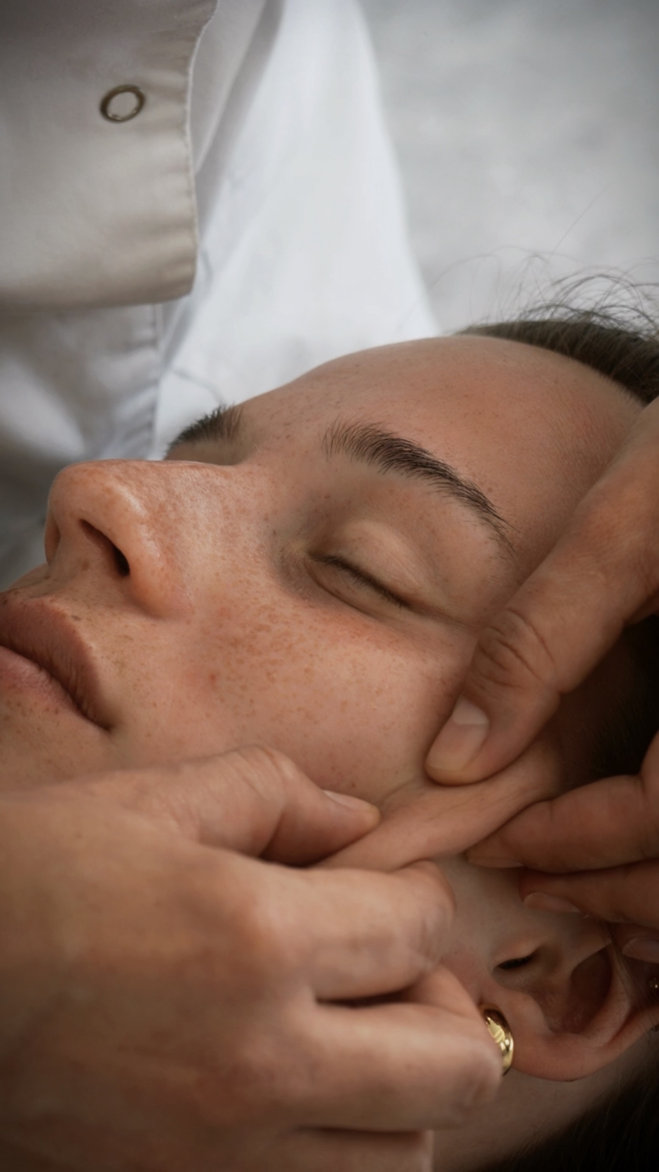 Woman receiving a relaxing facial treatment in a calm beauty studio