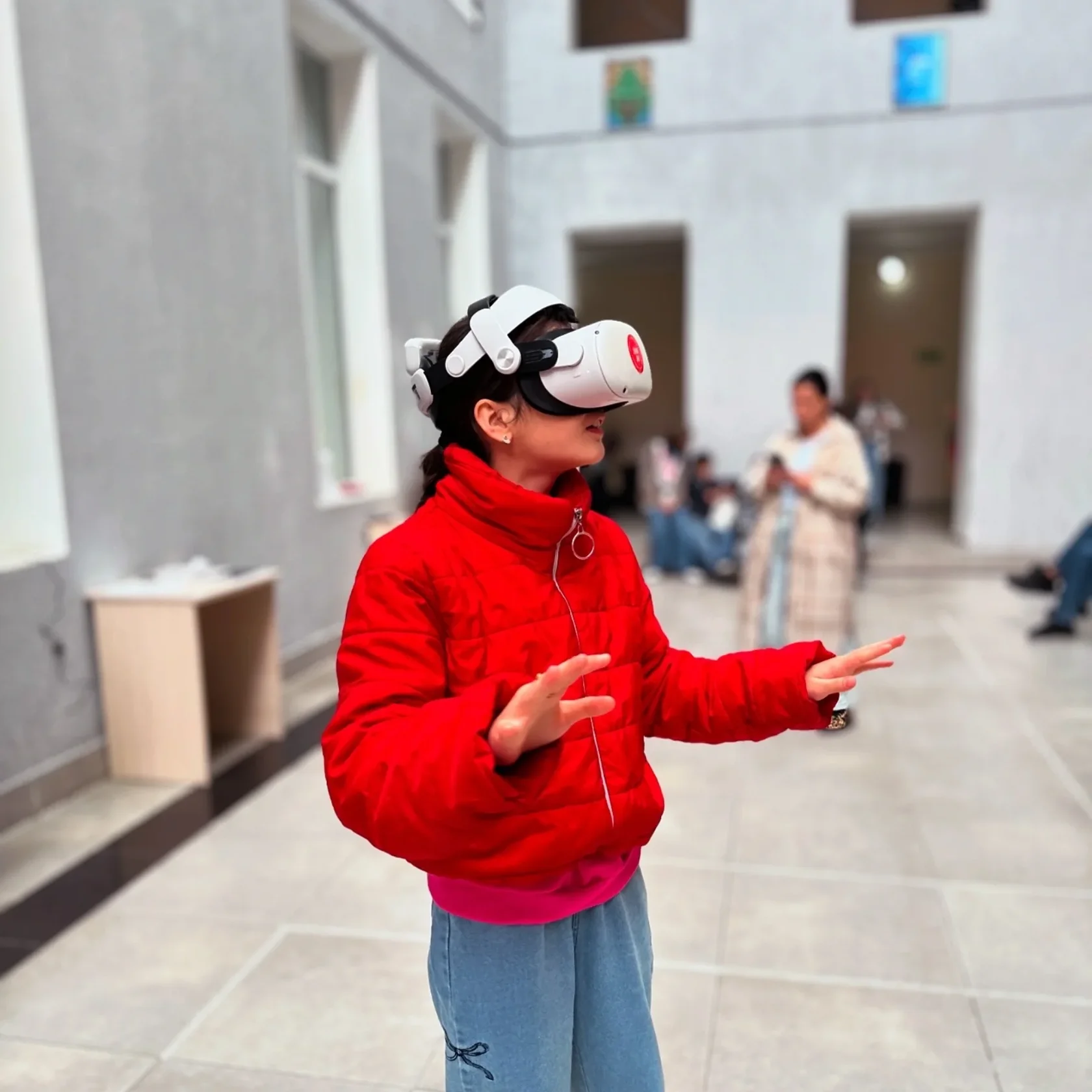 Visitor in a red jacket watching a 360 degree film at Batumi VR Days