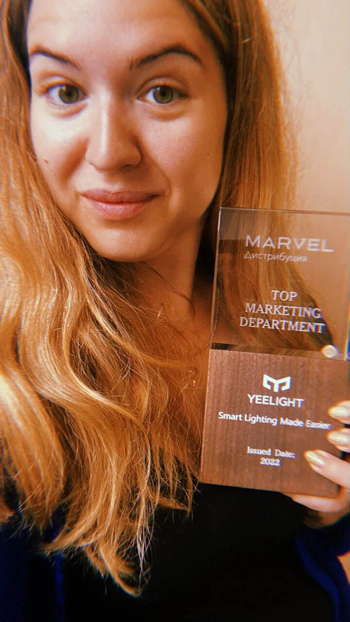 Photo with an award for a marketing project
