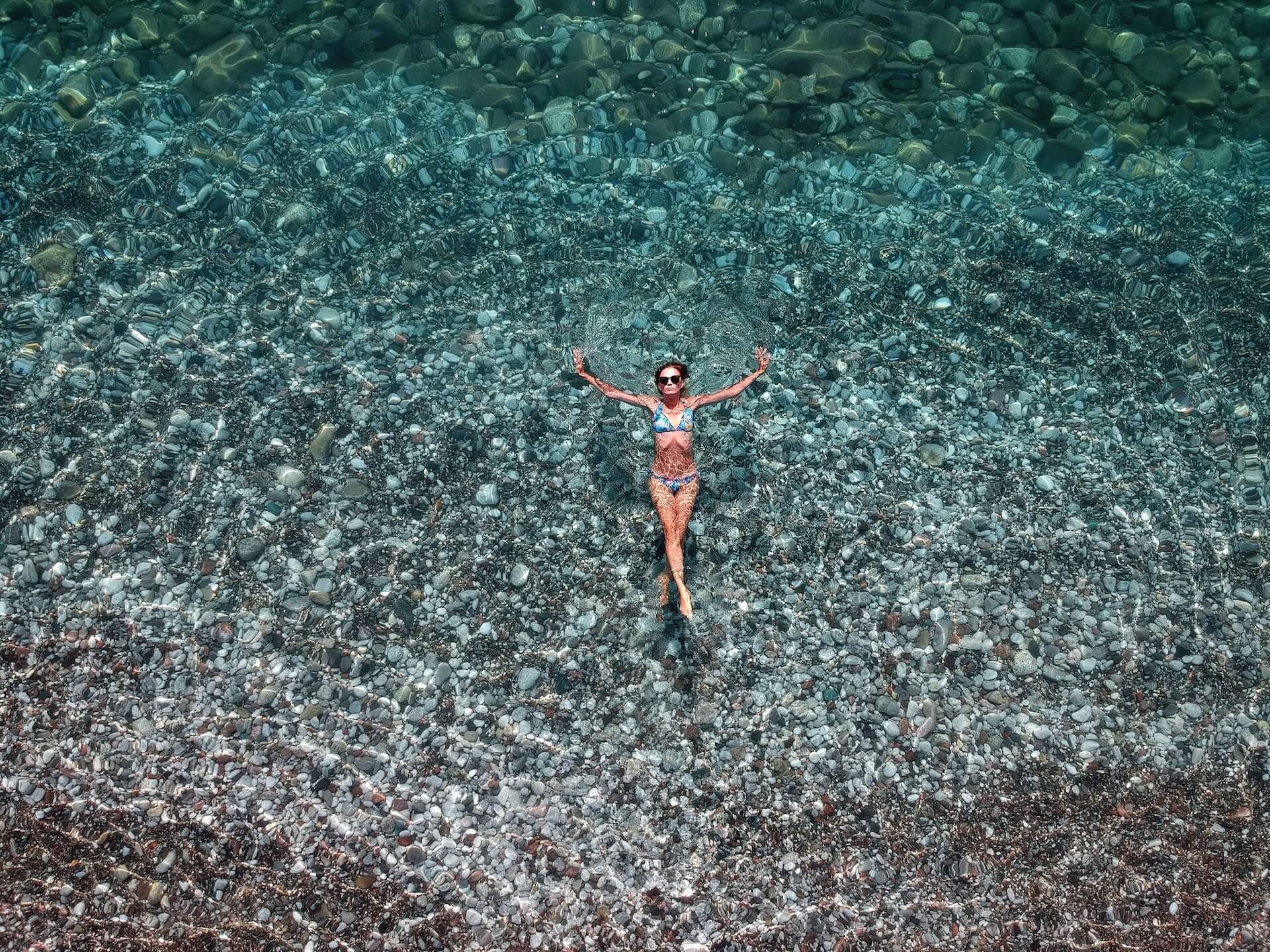 Guide to Montenegro - Woman floating in the crystal clear Adriatic sea