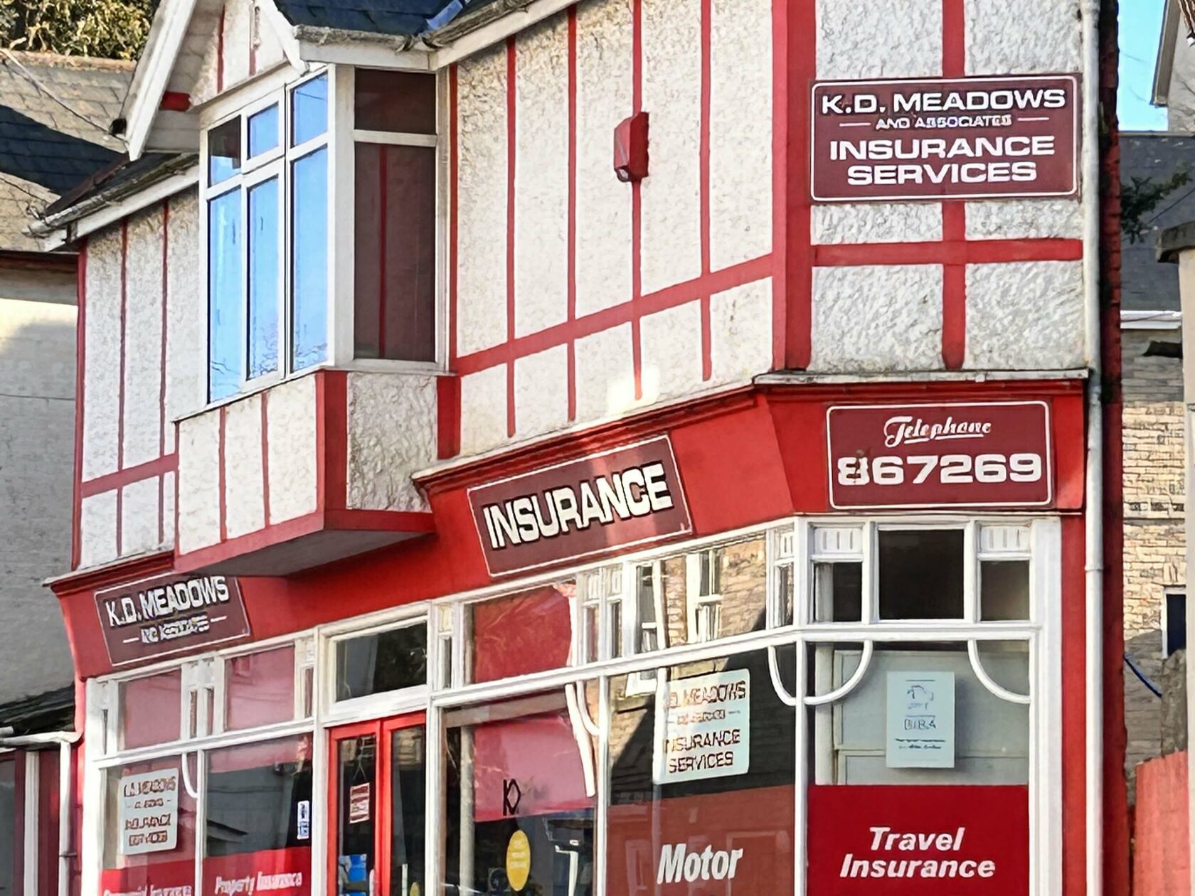 a red and white building with signs on the side of it