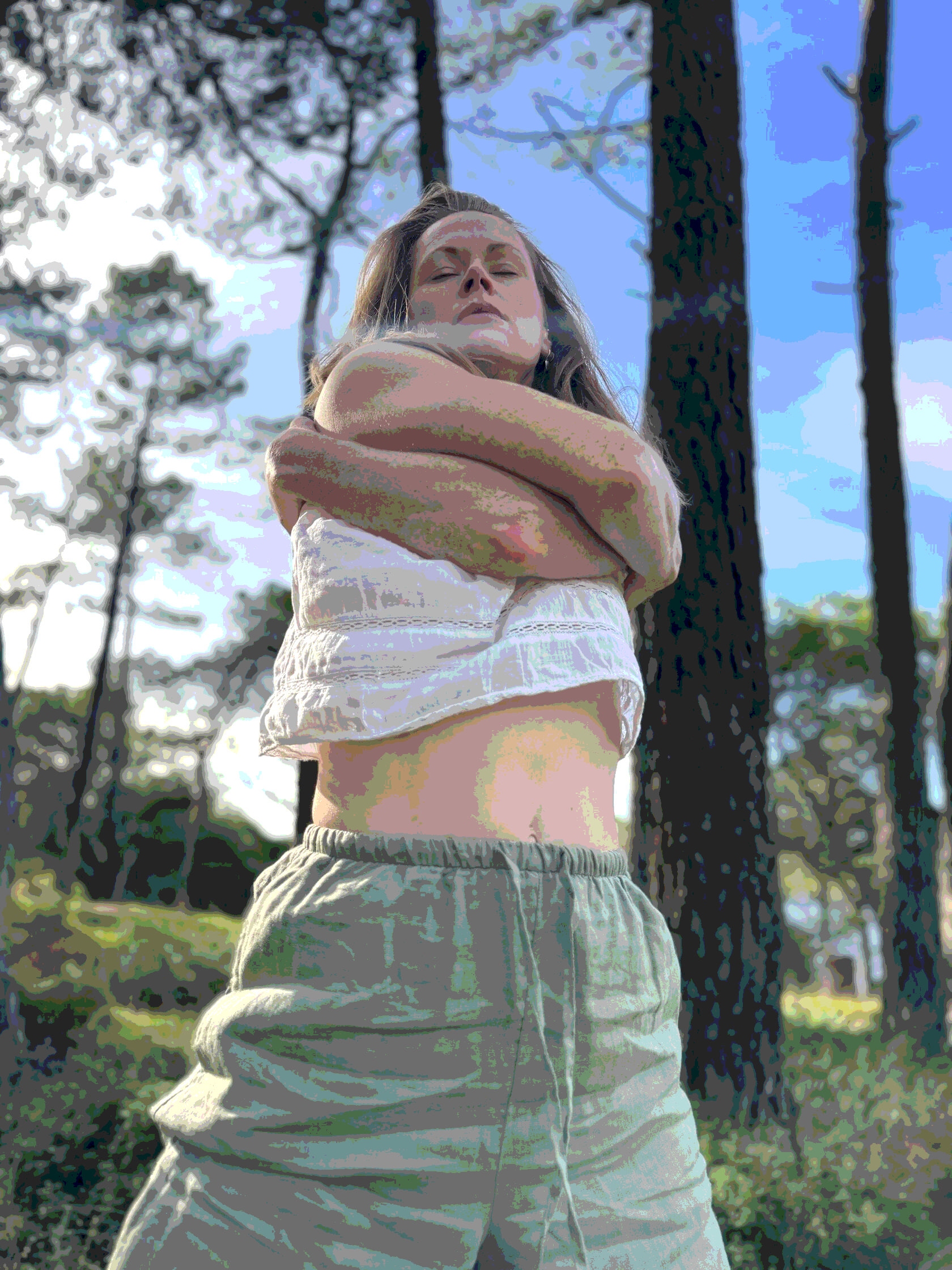 Woman in nurturing yoga pose, embodied practice