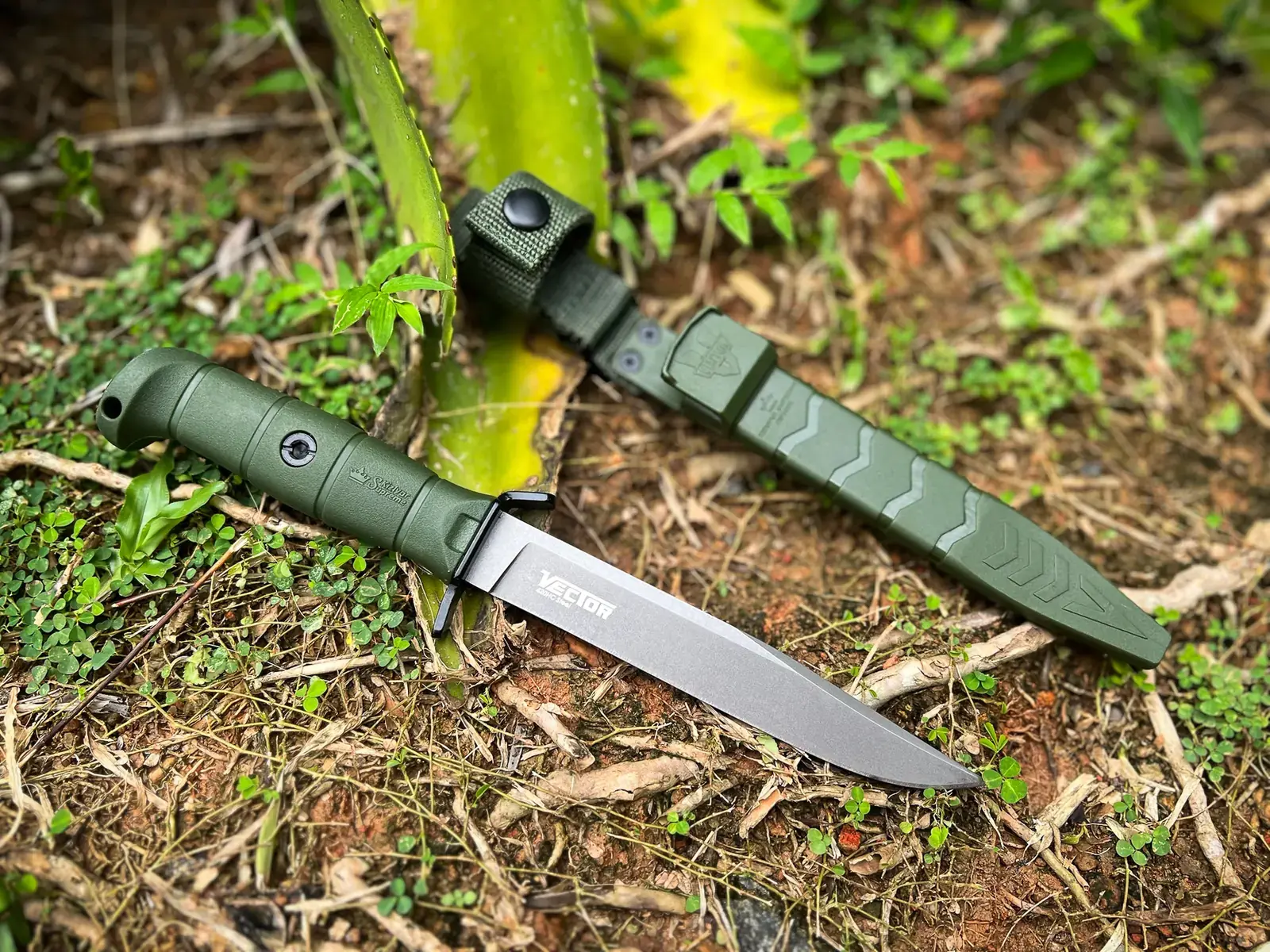 Olive Kizlyar Supreme Vector and matching sheath on a forest floor