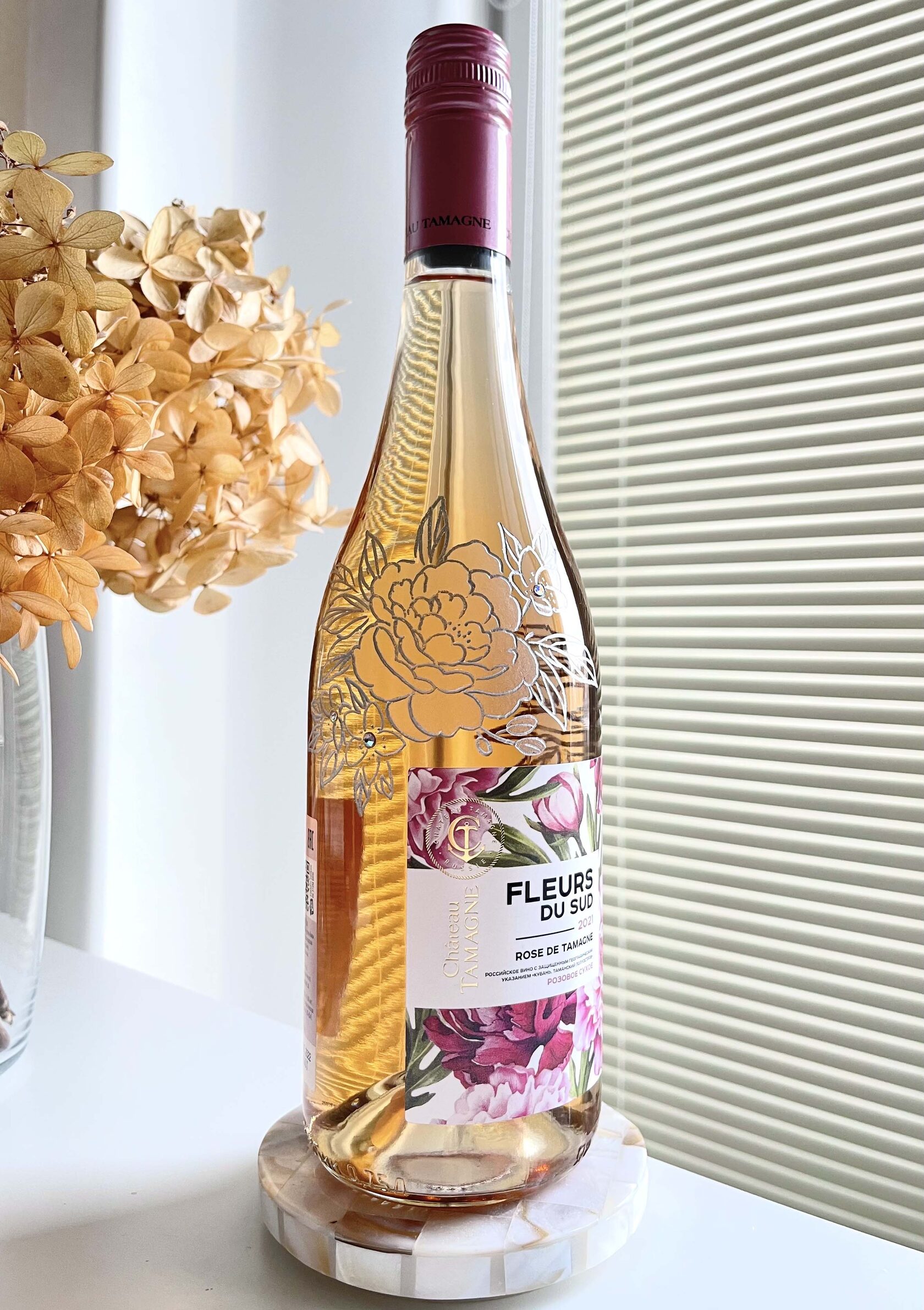 Engraved florals on wine bottle with silver fill