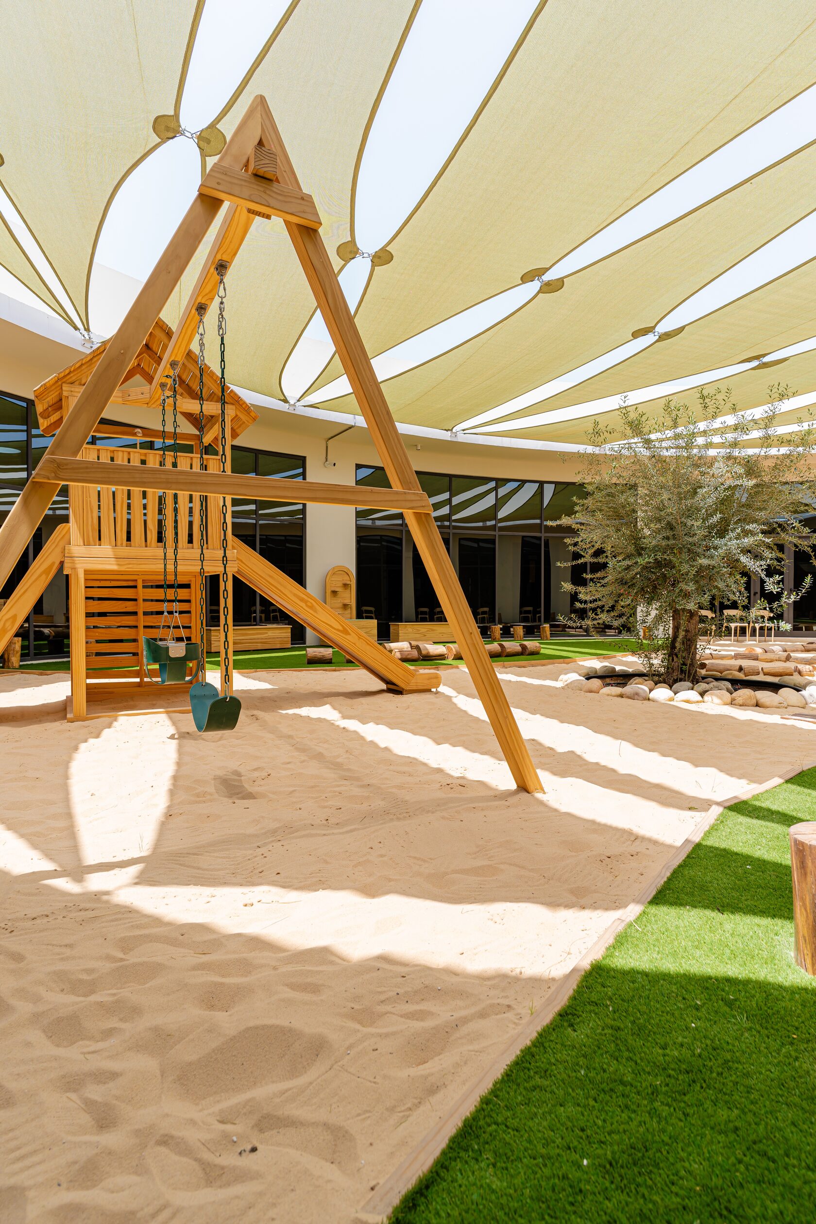 Outdoor play area with natural materials at Paddington Park EYFS nursery Dubai