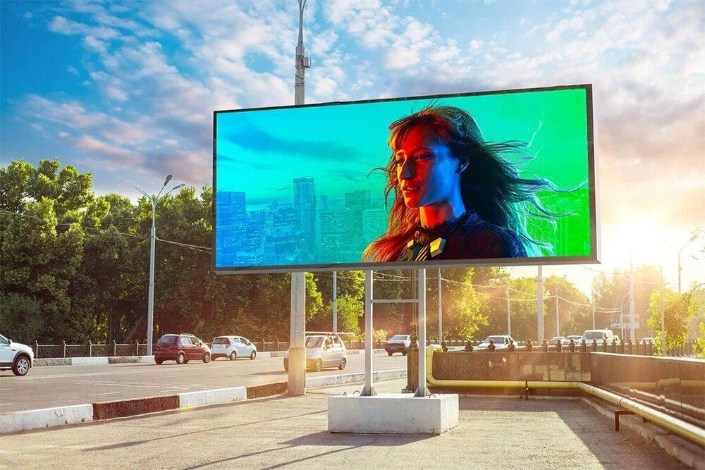 Modern outdoor LED billboard displaying dynamic advertising alongside a busy city road