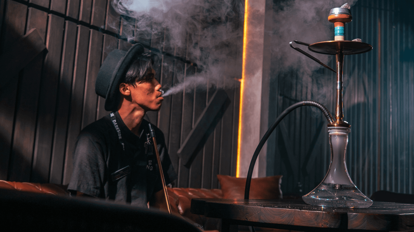 A Hookah beside a man with black suits