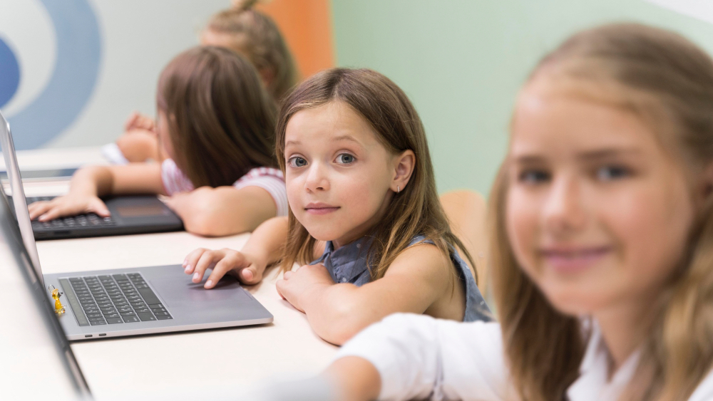 Young students learning how to use computers