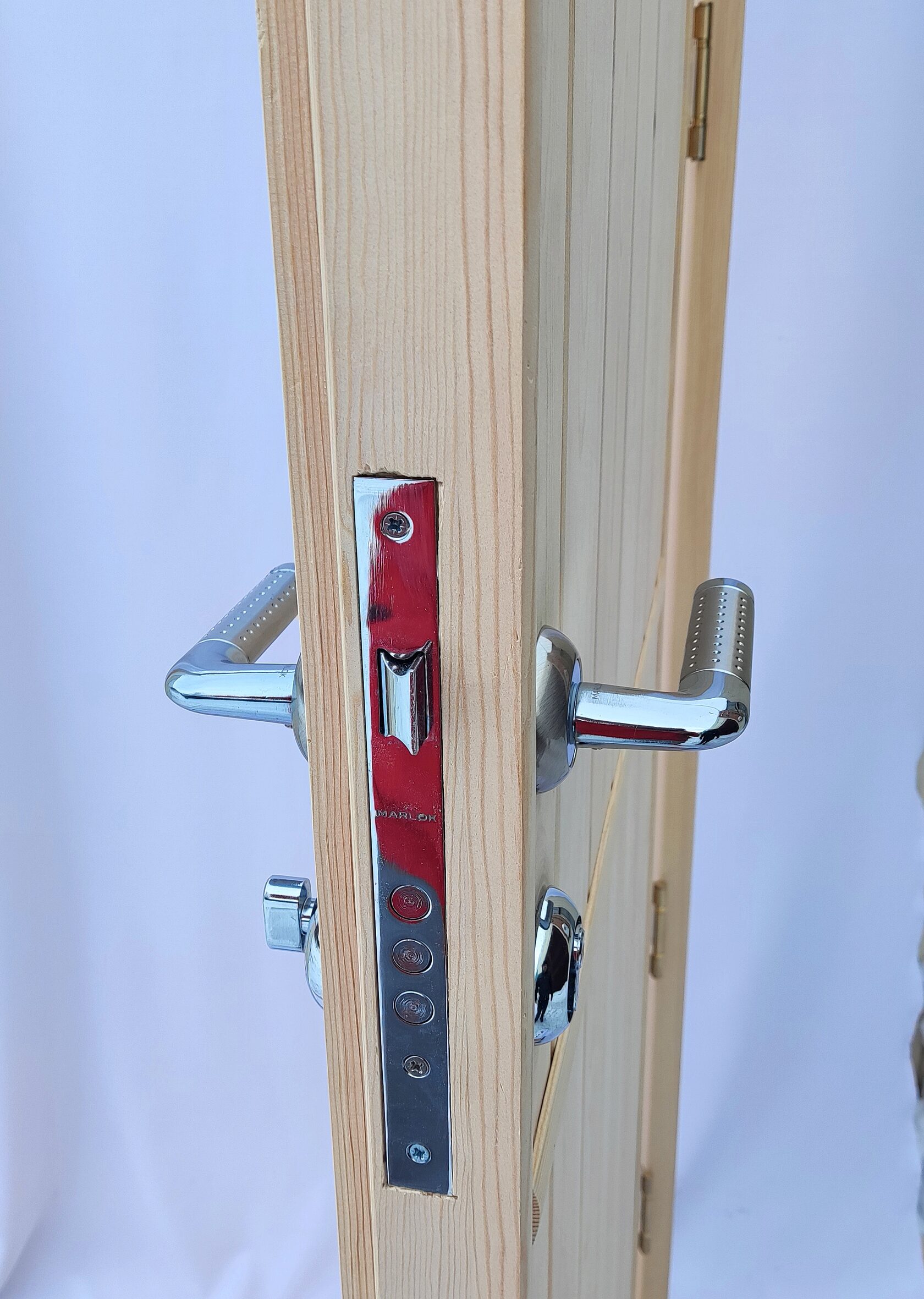 металлическая ручка и замок для входной двери из дерева