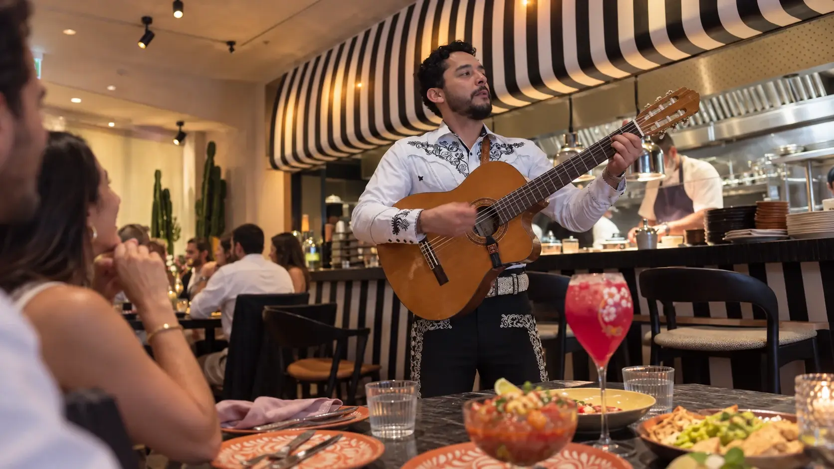 Brunch atmosphere visual: guitarist performing beside guests at Sobremesa
